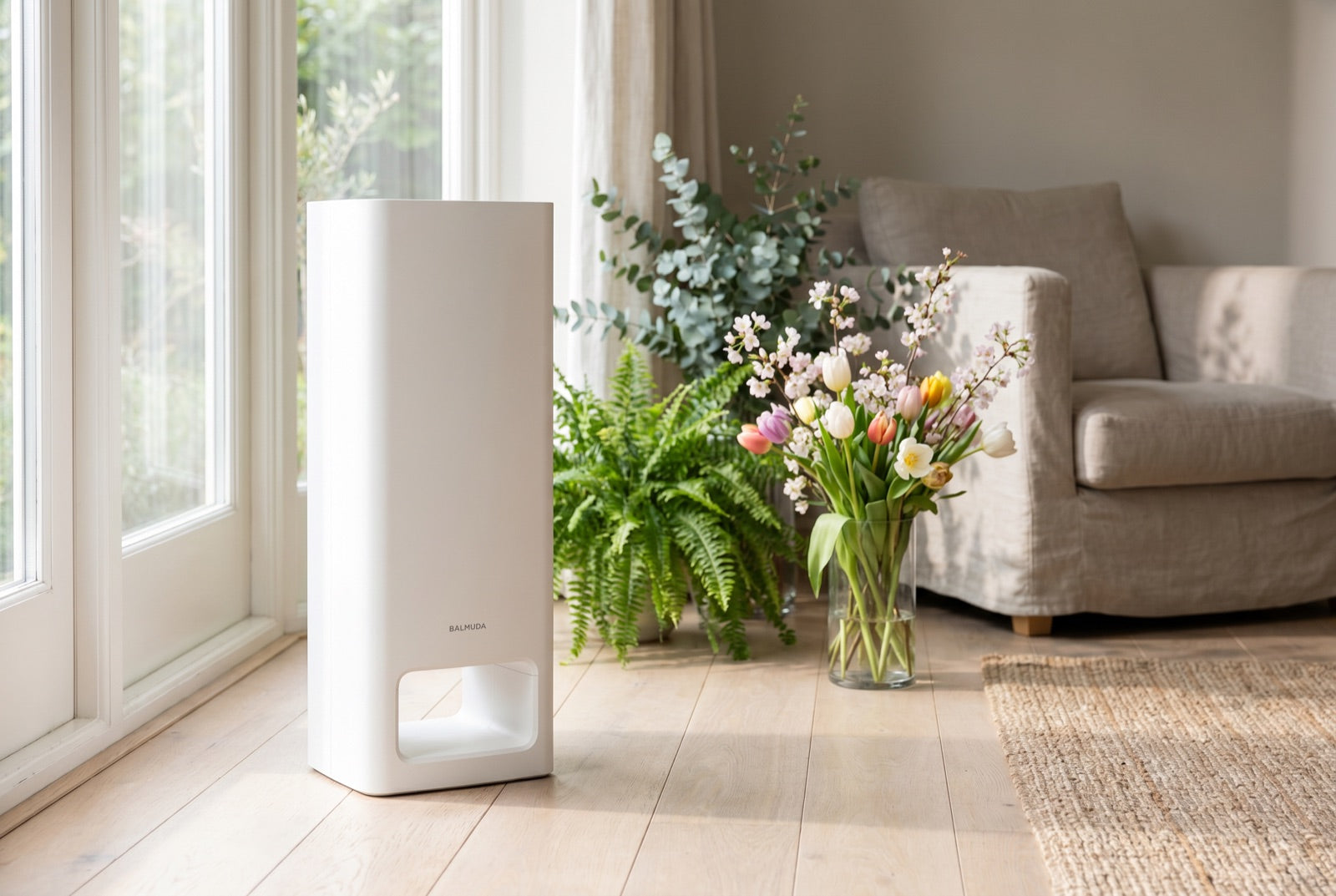 BALMUDA The Pure air purifier with spring flowers in a bright UK home