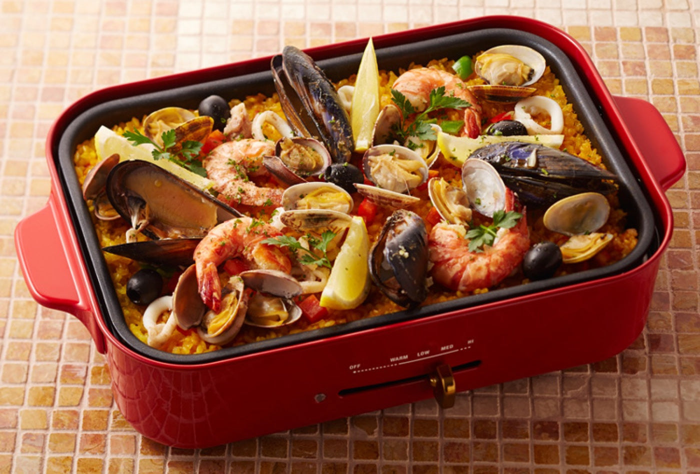 Seafood paella cooked on the BRUNO Compact Hot Plate